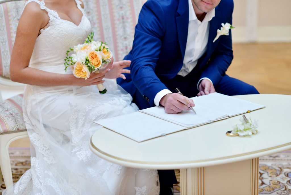 Beauty bride and handsome groom are registering the marriage